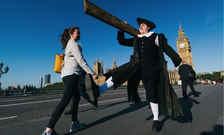 A man carrying a plank in the streets of London