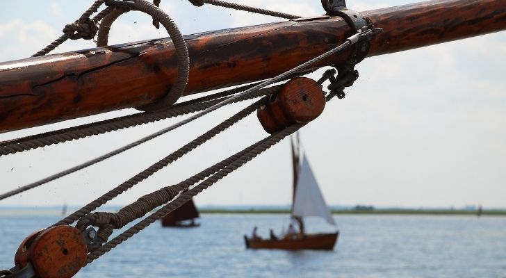 A picture of the jibboom and a boat in the distance