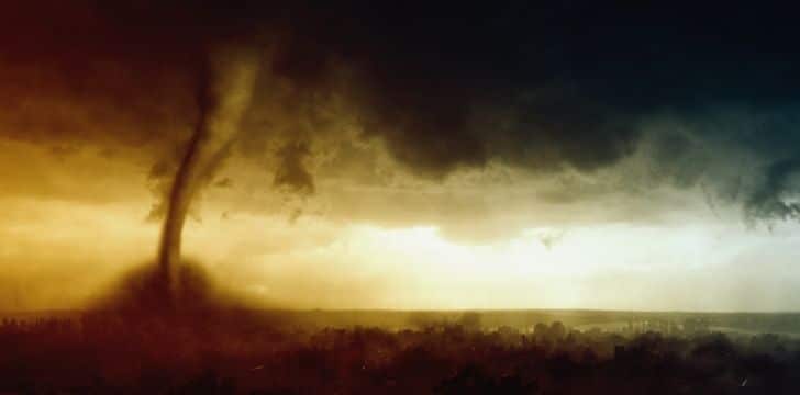 A scary tornado ripping across ground