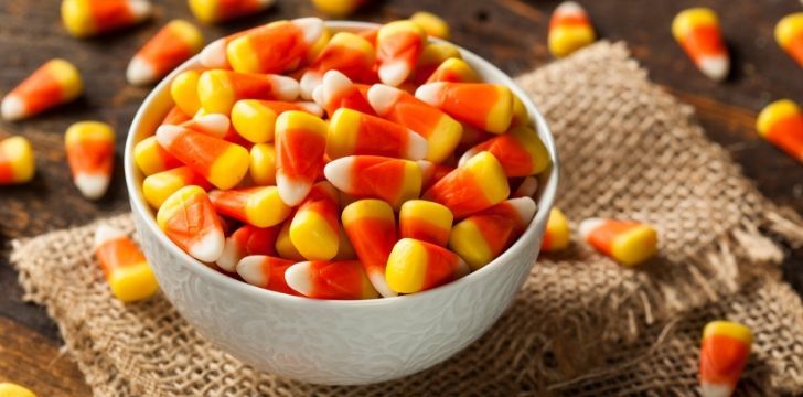Candy corn in a white bowl.