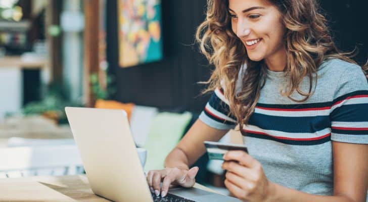 Woman shopping online with her credit card out