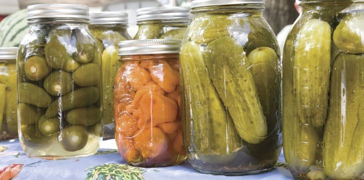 A mix of jars with pickles and pickled carrot