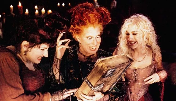 Hocus Pocus scene with three witches looking at the spell book