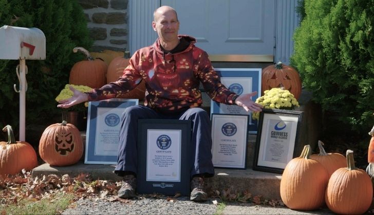 A picture of Stephen Clarke with many certificates