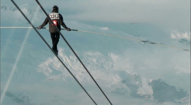 Freddy Rock walking a zip line that's incredibly high