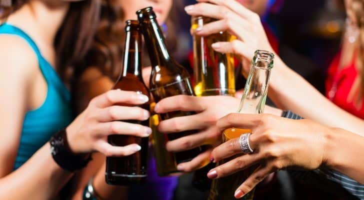 A group of people cheering bottles.