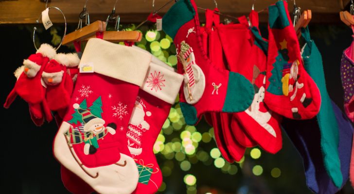 Lots of Christmas stockings hanging on the fire place