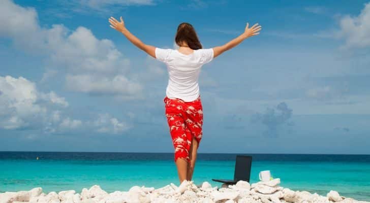 A woman on the beach with her laptop