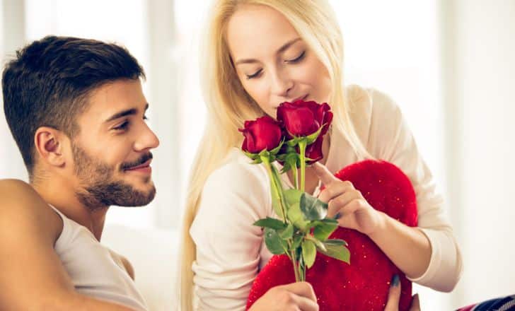 A man giving roses to a woman.