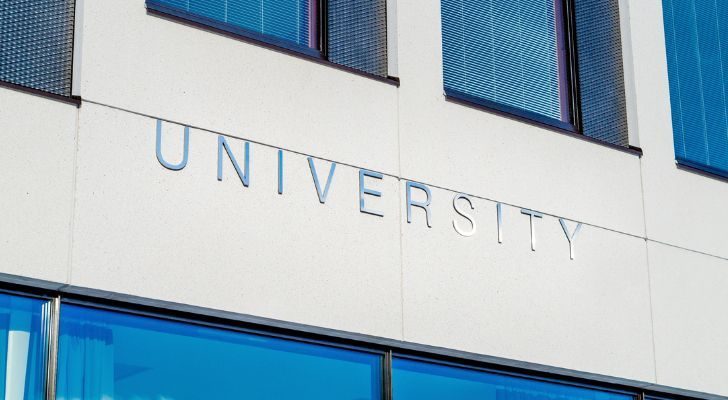 A sign reading "University" on the side of a building