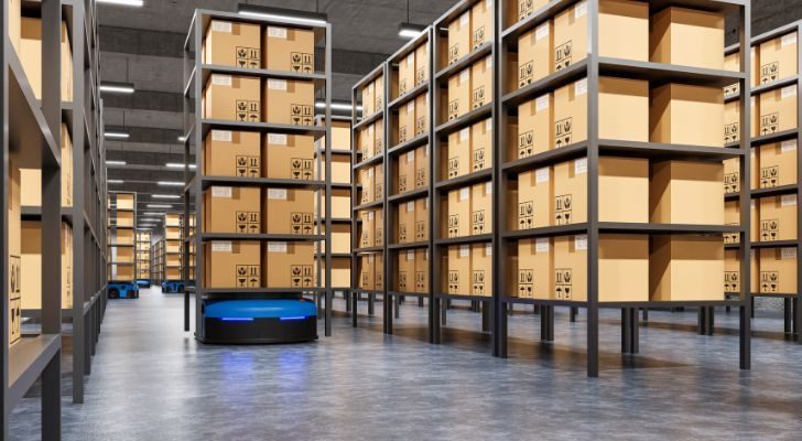 A warehouse with many boxes stacked high and into the distance