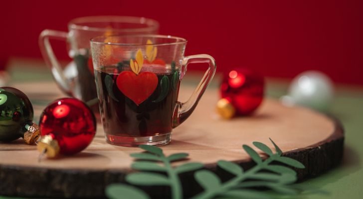 Two small glasses of glögg amongst festive decor