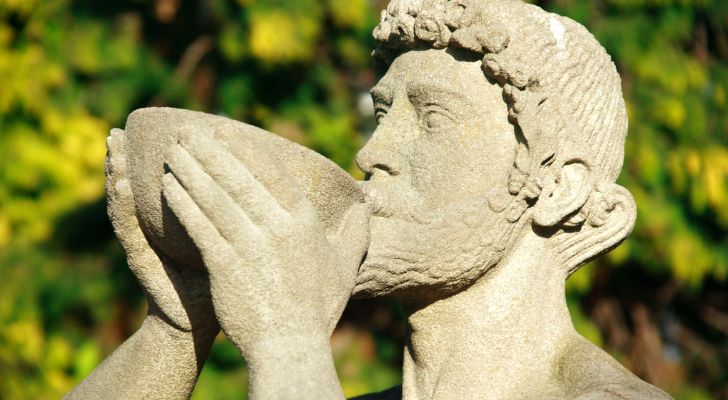 A statue of the Roman god Bacchus drinking wine