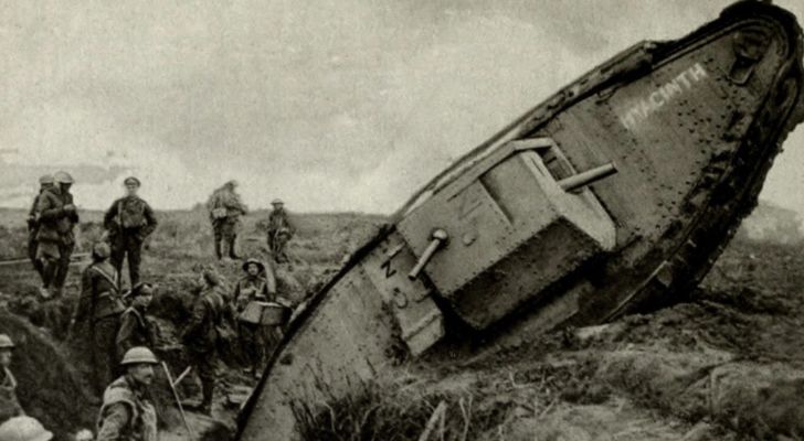 A British WWI tank climbs its way out of a trench