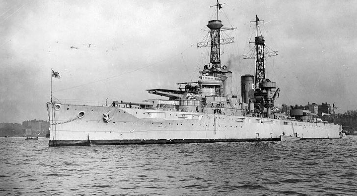 The USS Texas Dreadnought-class battleship sits in the water with may guns and towers