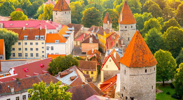 Tallinn's Old Town in summer with trees dotted between the medieval towers