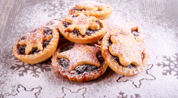 Minature pies with patterns on top sit in a pile