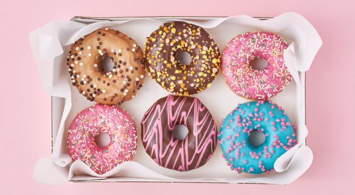 Six colorful donuts arranged in a box