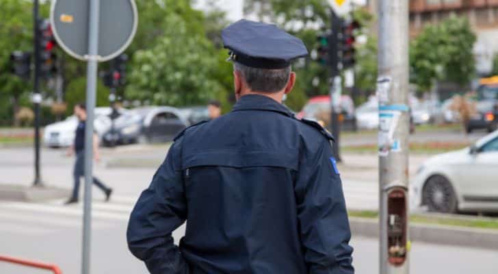 A police officer looking out on a street