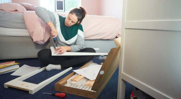 A woman assembling flatpack furniture