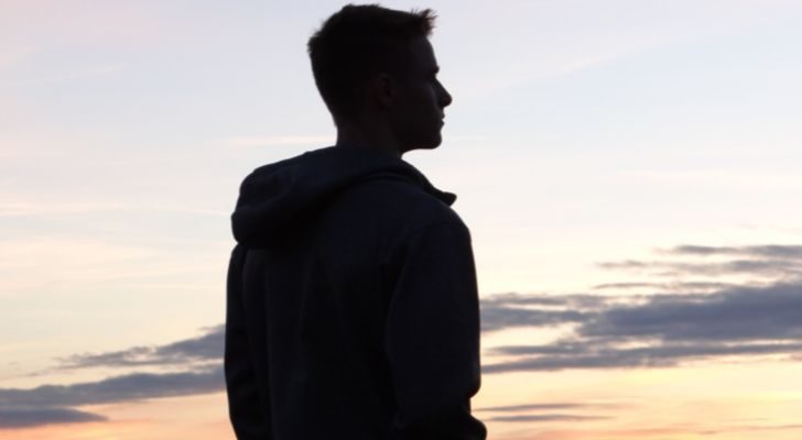 A young boy watching a sunset