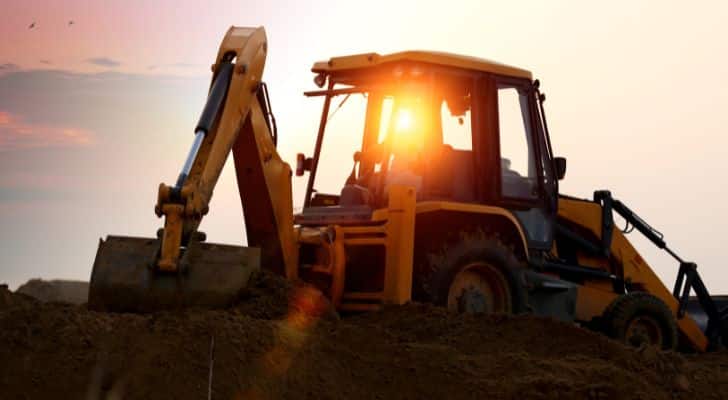 A tractor working during sunset