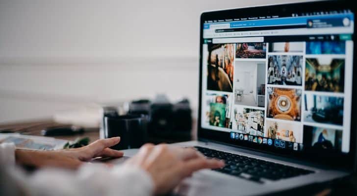 A person looking at images on a laptop