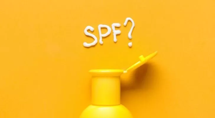 The letters "SPF" spelled out in sunscreen