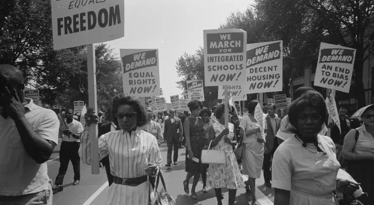 A crowd of African Americans holding up signs asking for equal rights