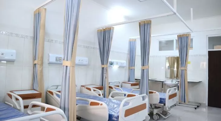 A hospital room with empty beds