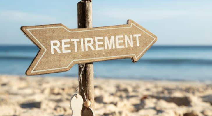 A wooden sign on a beach that reads "Retirement"