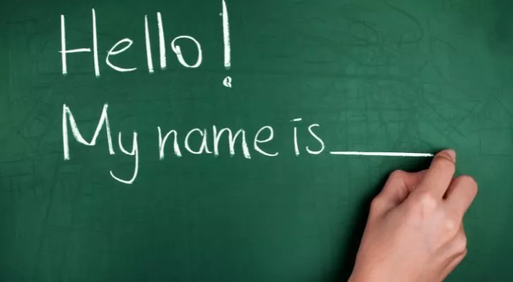 Someone writing "Hello! My name is" on a chalkboard