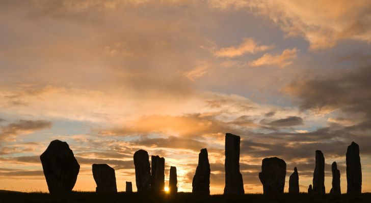 A circle of standing stones in Scotland during sunrise on the summer solstice