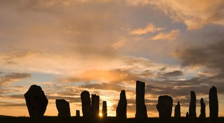 A circle of standing stones in Scotland during sunrise on the summer solstice