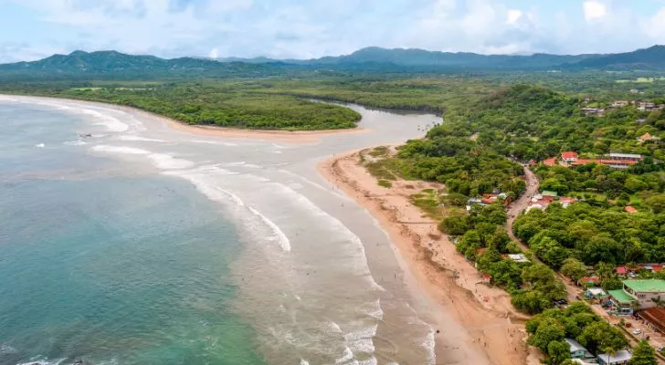 A wide river flows into the sea in Costa Rica. 