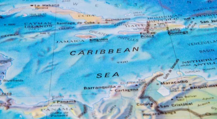A map of the world shows the Caribbean Sea and the surrounding islands