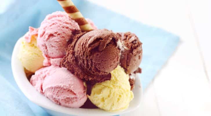 Scoops of chocolate, vanilla and strawberry ice cream served in a bowl