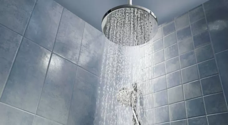 A running showering with multiple metal shower heads