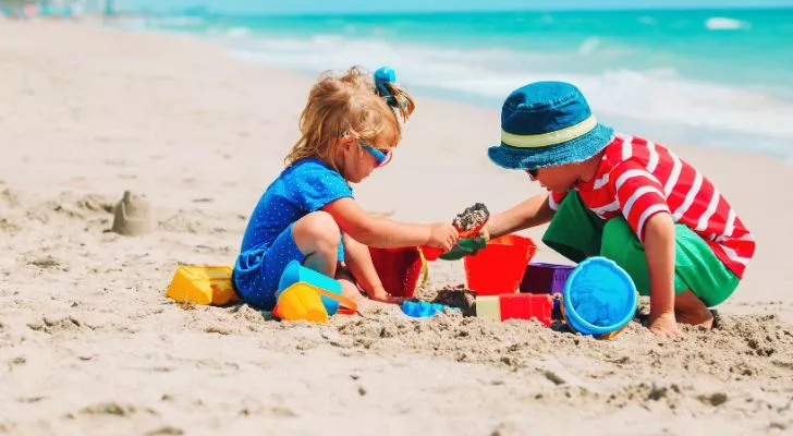 Two children building sandcastles on the beach