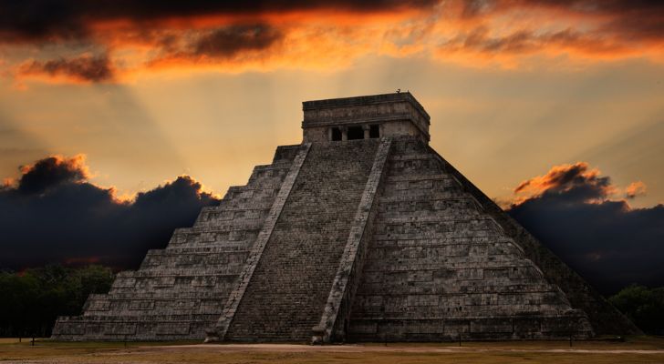 An ancient Mayan pyramid in Chichen-Itza, Mexico at sunset