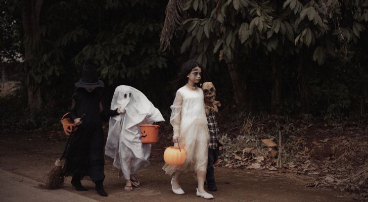 Kids in various halloween costumes going trick-or-treating