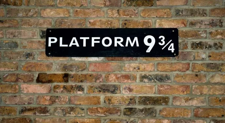 A sign on a brick wall reading "Platform 9 and 3/4"