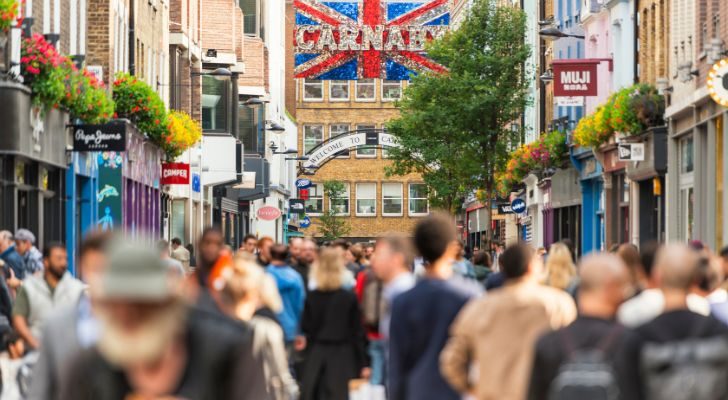 A large crowd of various ethnicities on Carnaby Street in London