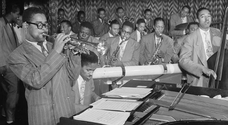 Trumpeter Dizzy Gillespie playing as part of a Jazz band during the Harlem Renaissance