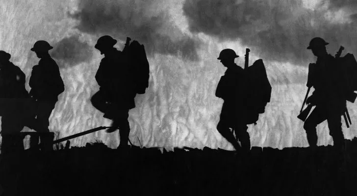 The silhouettes of WWI soldiers walking across a battlefield