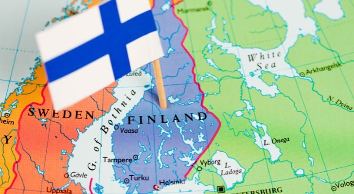 A map of Scandinavia with a small Finnish flag stuck into Finland