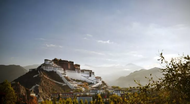 A view of Potala Palace in Tibet amongst the surrounding mountains