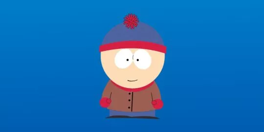 Stan Marsh from South Park wearing his iconic blue and red beanie, brown jacket, red mittens, and blue pants against a blue background.