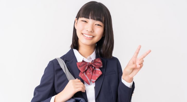 A young girl in an East Asian school uniform