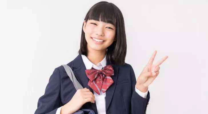 A young girl in an East Asian school uniform